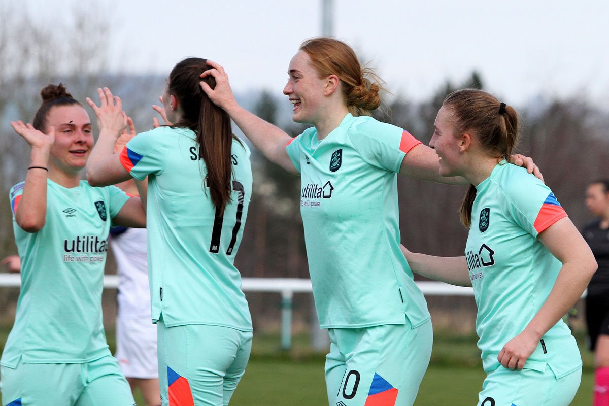 Huddersfield celebrate the opening goal by Brittany Sanderson (second left)