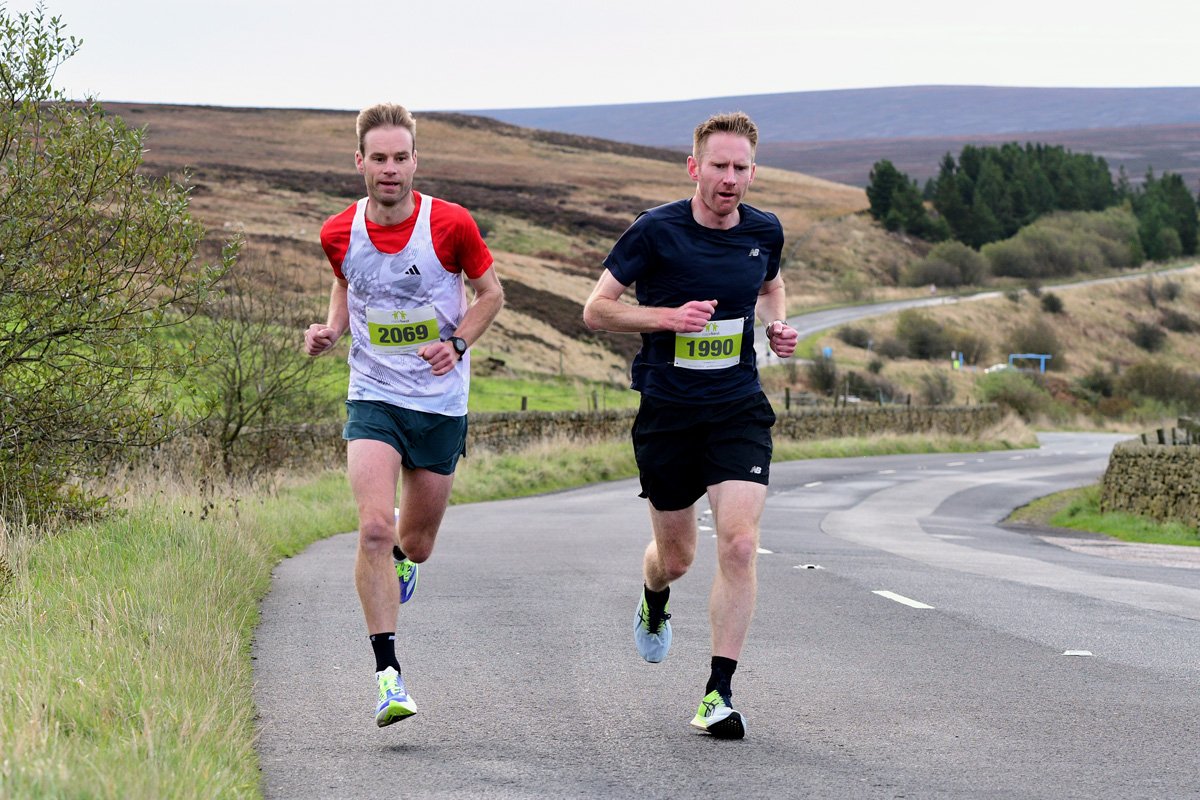 Holmfirth 10K, a scenic route around Hade Edge and Winscar Reservoir. Mens race winner Alex Whittem (left) leads runner-up Ben Jarvis.